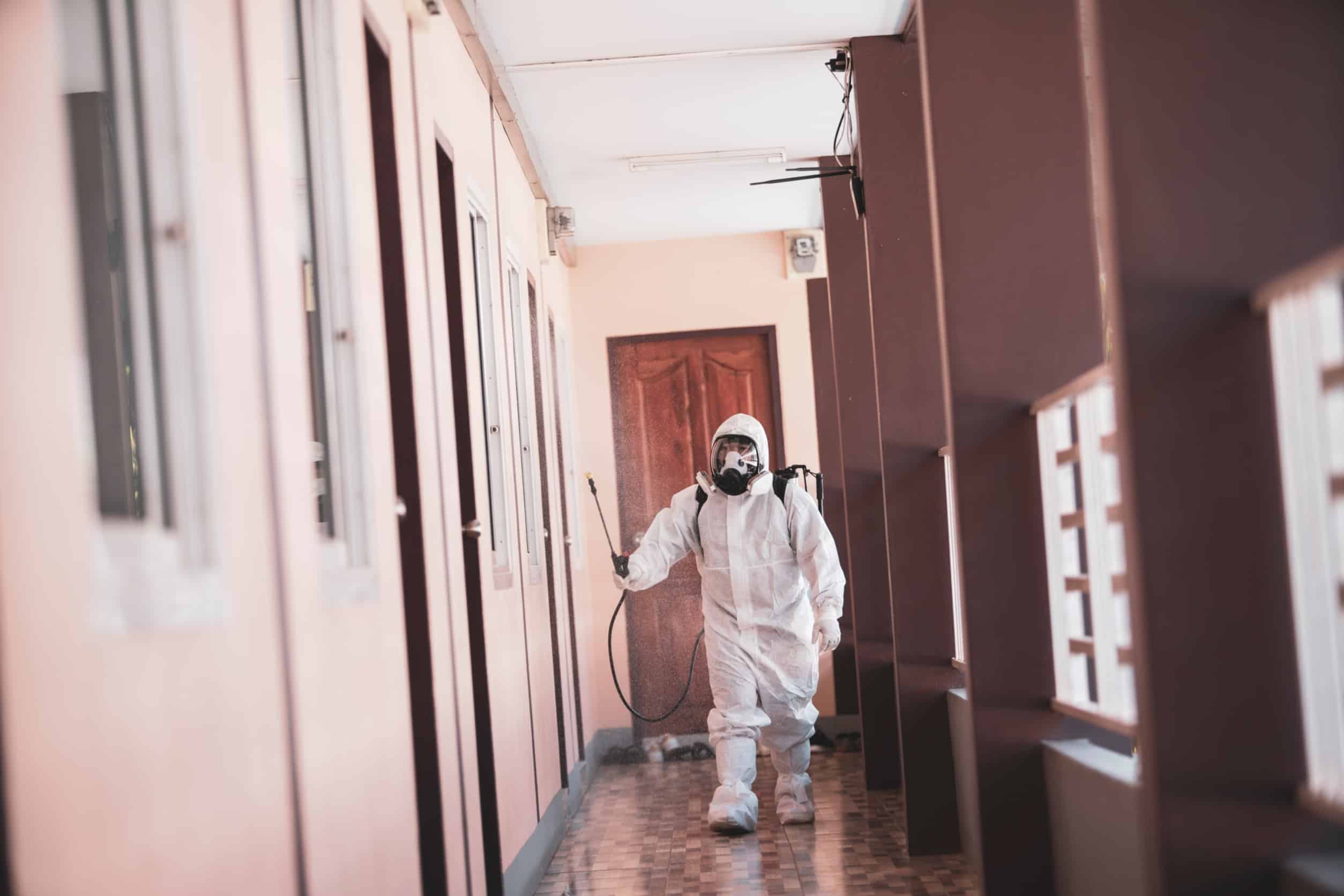 防疫人員穿著防護服進行消毒作業.