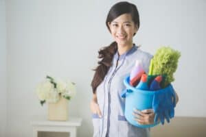 打掃清潔工 woman holding cleaning supplies in uniform for hospitality service and housekeeping.