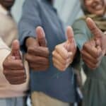 多元國際外勞集團展示團隊 thumbs up 表示肯定與合作成功.