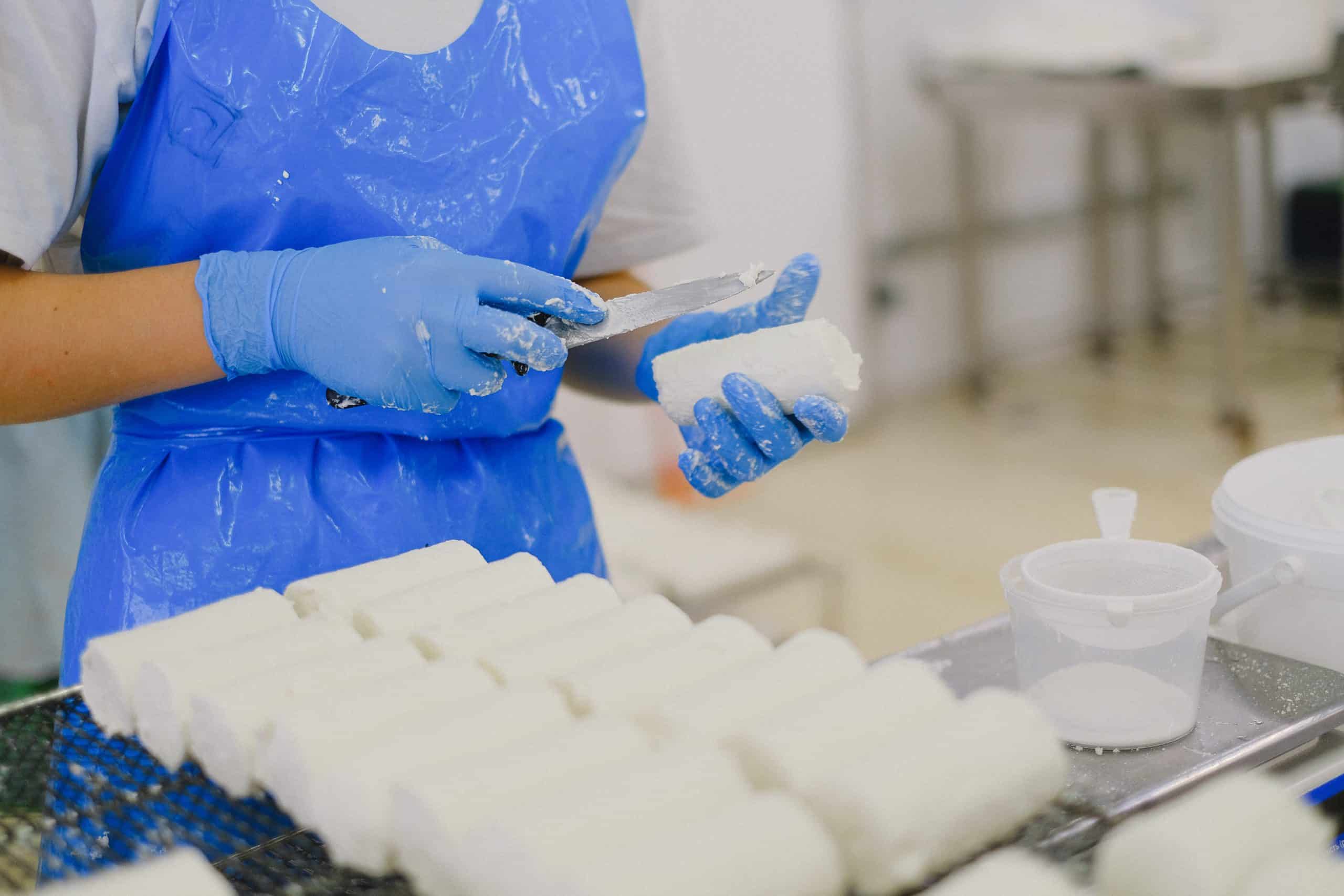 奶酪製作過程，外勞在工廠手工切割奶酪，展現精湛技藝與專業技能。.