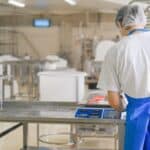 手機稱重工人在食品加工工廠內進行產品稱重工作.