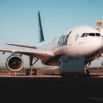 737plane landing at airport with Azul Airlines branding, focus on international travel and airline services.