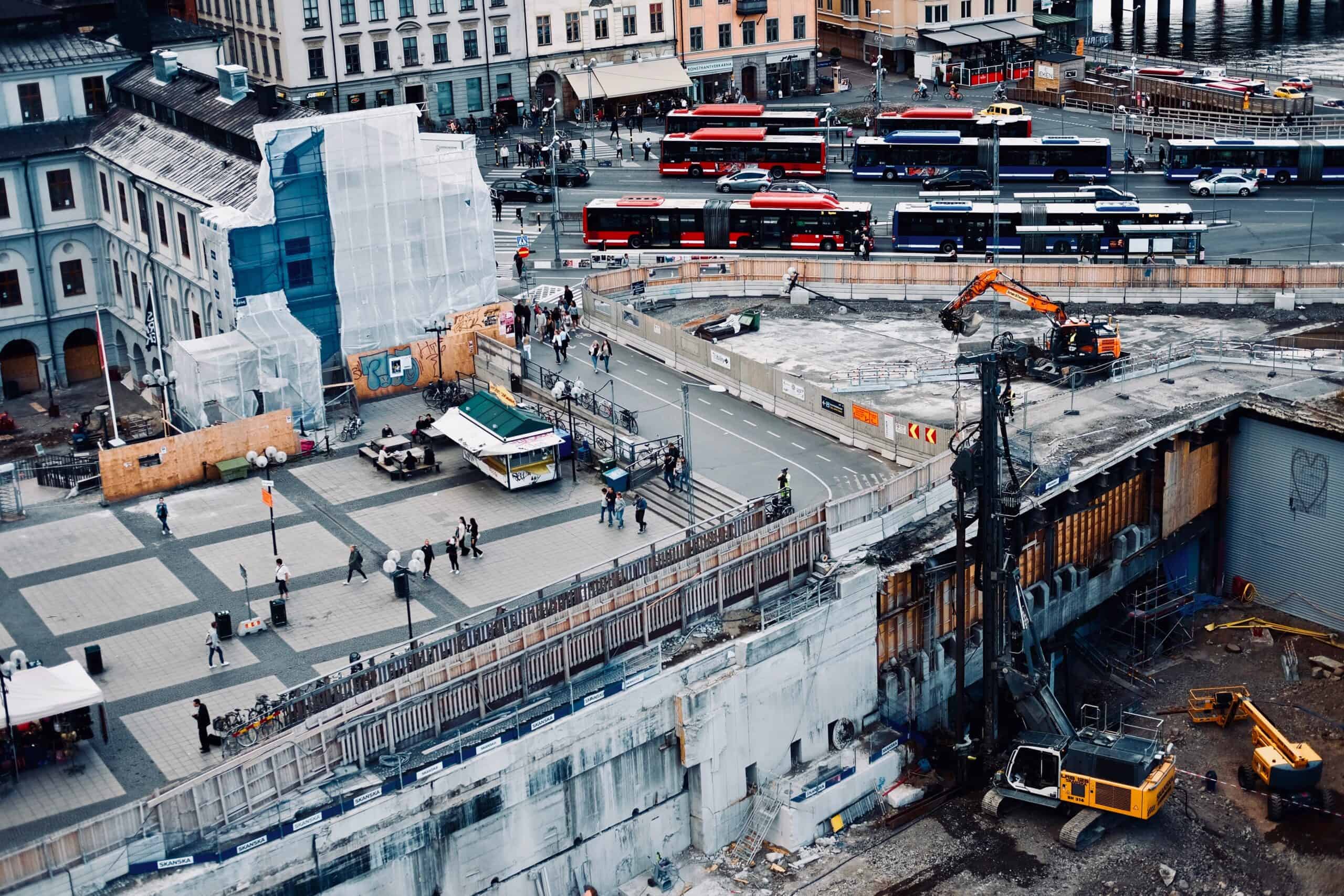 繁忙城市建設工地，施工中的混凝土拆除與工程機械作業場景。.