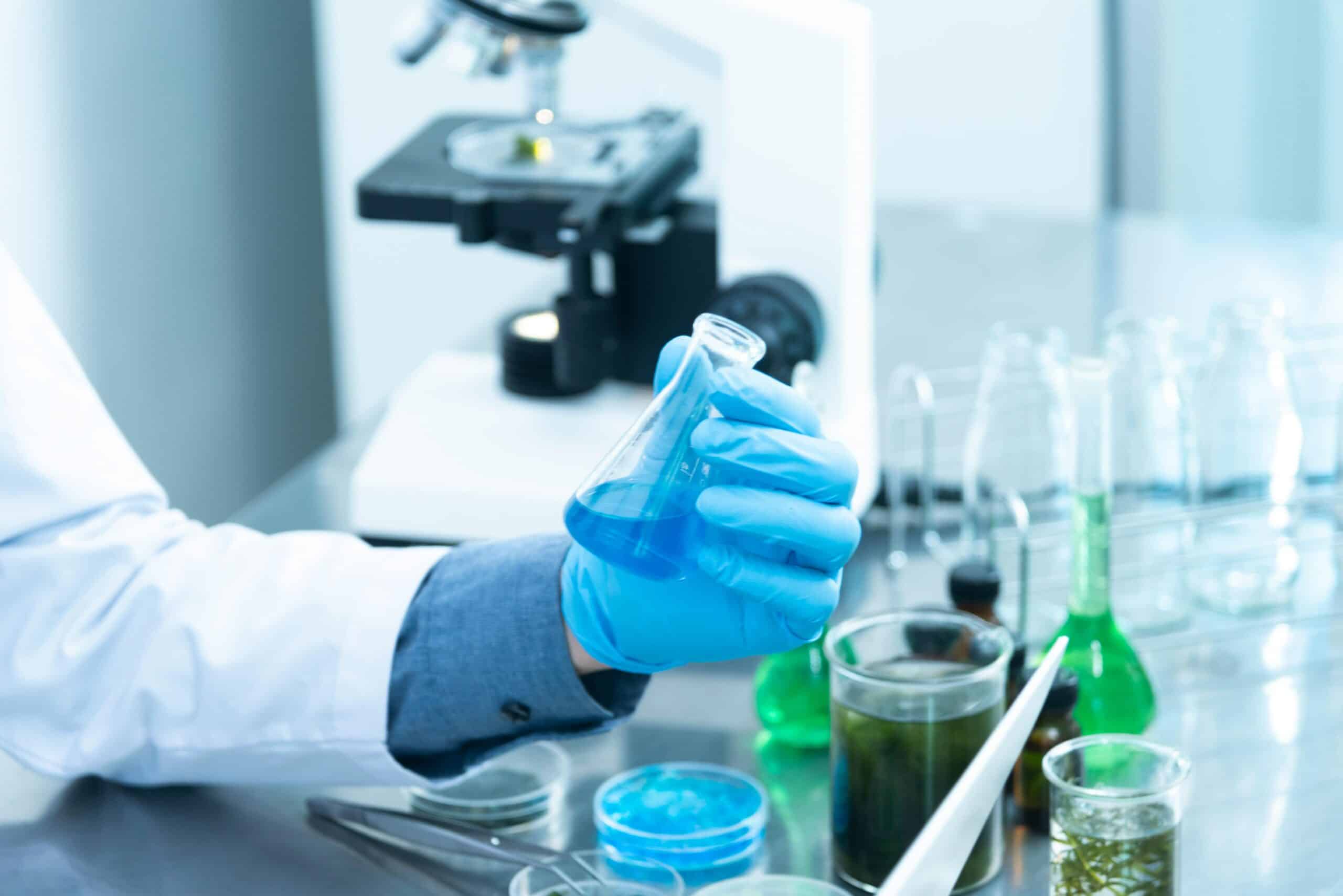 实验室工作人员进行化学实验，关注科学研究和实验安全。.
